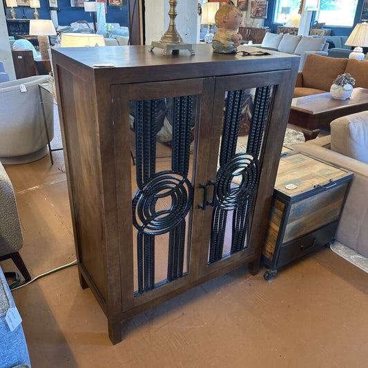 Wooden console table with decorative metal accents in a furniture store setting