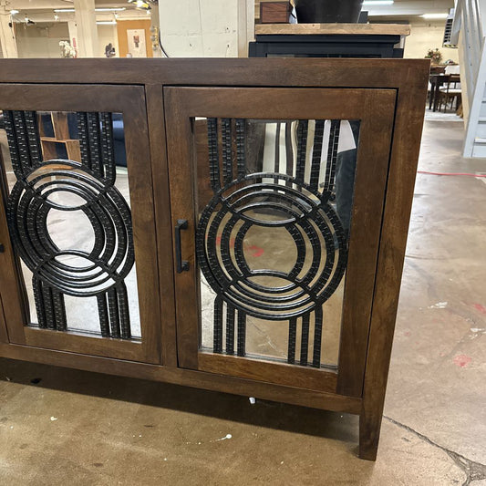Wooden cabinet with decorative metal panels in a store setting
