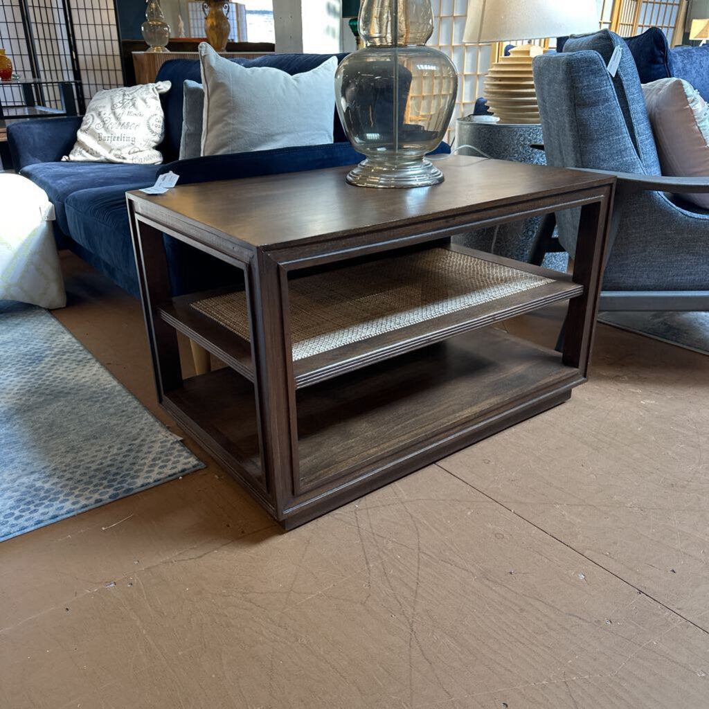 Wooden coffee table in a living room setting with furniture and decor.