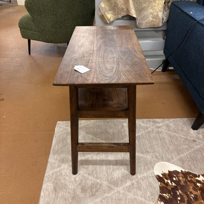 Wooden side table in a room with furniture and decor