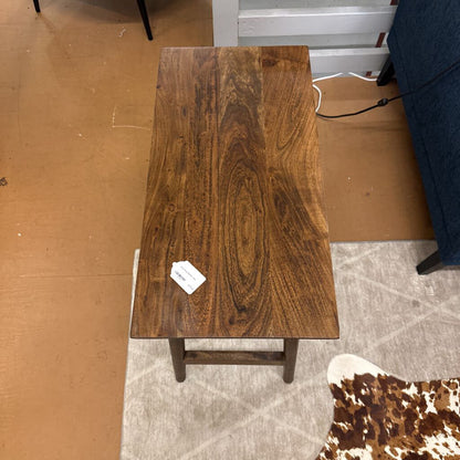 Wooden table with a price tag on a carpeted floor