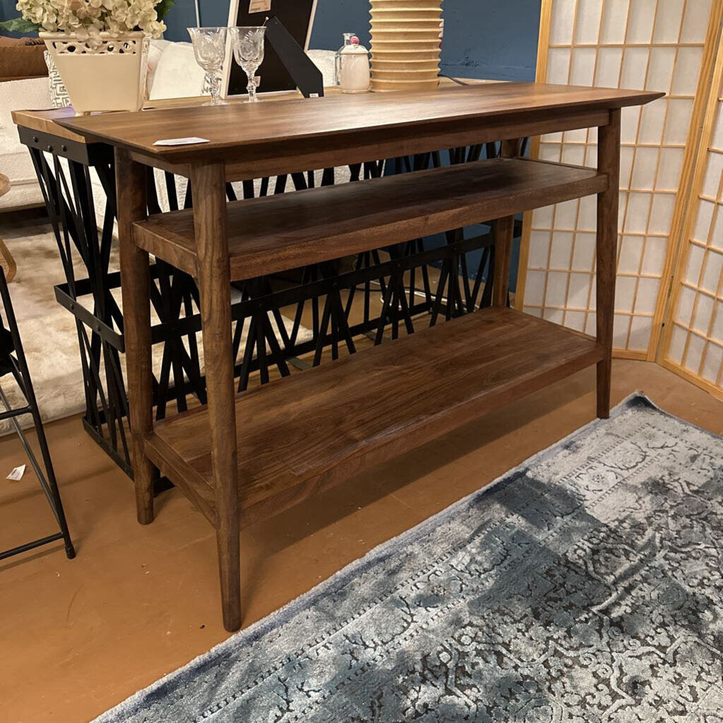 Wooden console table with shelves in a room setting