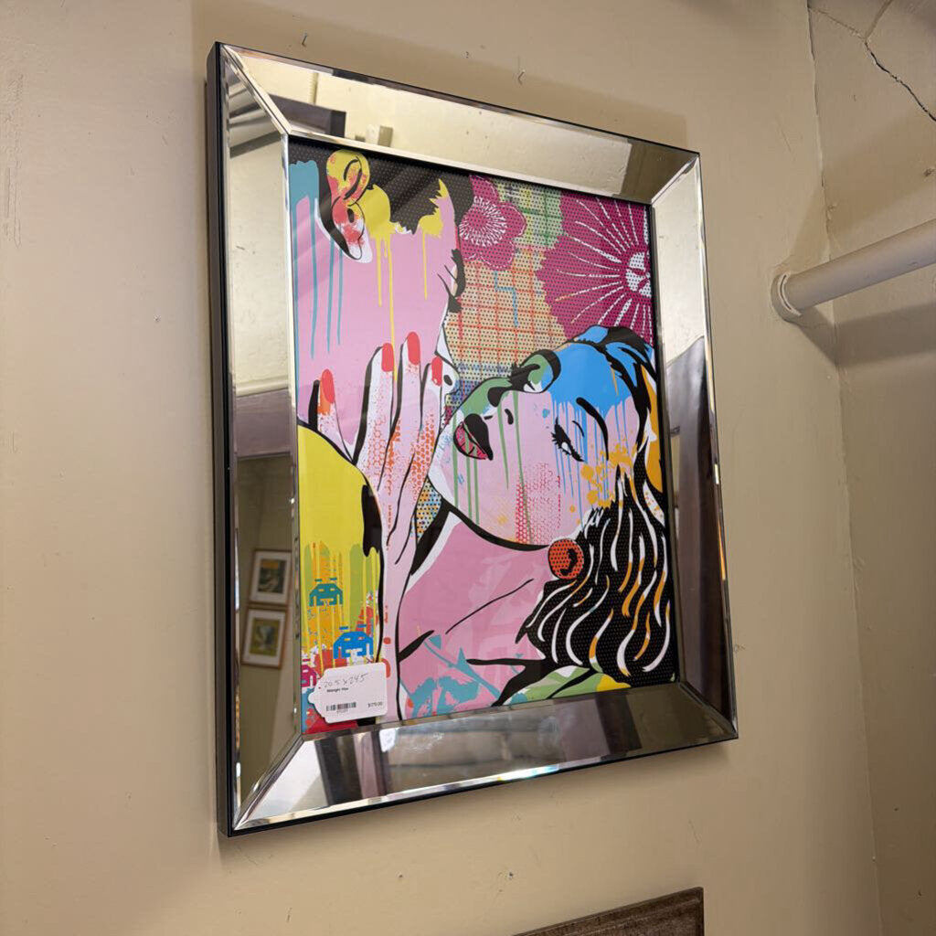 Colorful abstract artwork on a mirror-framed wall