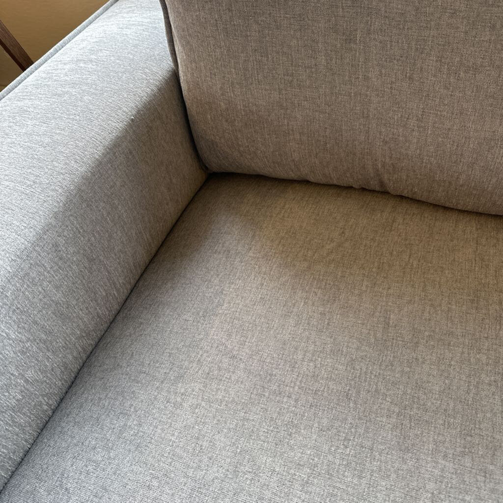 Close-up of a beige fabric sofa corner