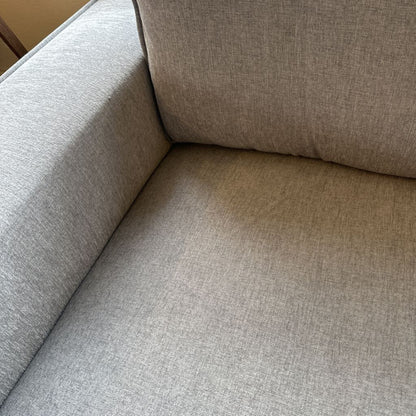 Close-up of a beige fabric sofa corner