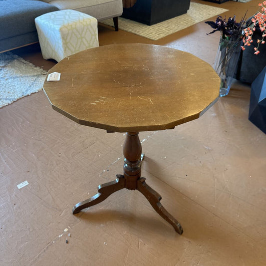 Wooden round table with a pedestal base in a room setting