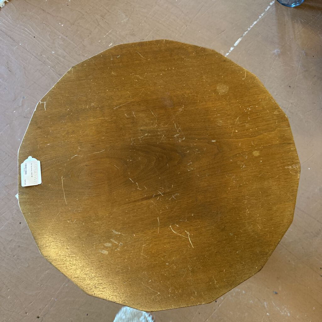 Gold circular object on a cardboard background
