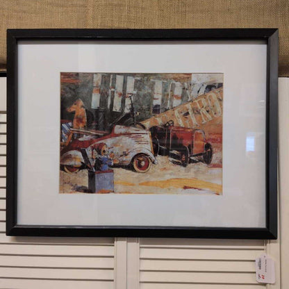 Framed artwork of an old truck on a textured wall