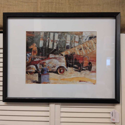 Framed artwork of an old truck on a textured wall