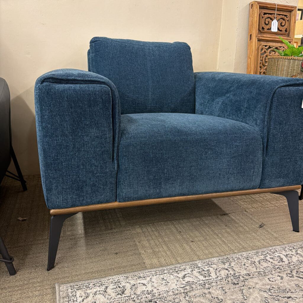 Blue sofa with wooden legs in a room setting