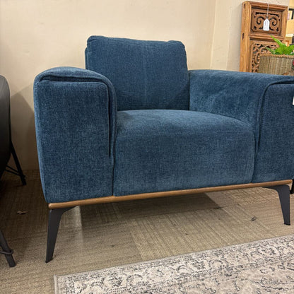 Blue sofa with wooden legs in a room setting