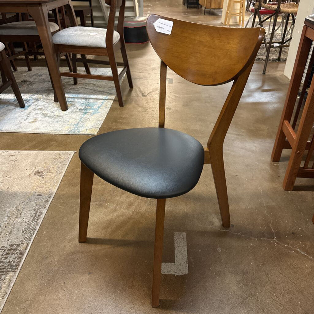 Wooden chair with a black seat in a store setting
