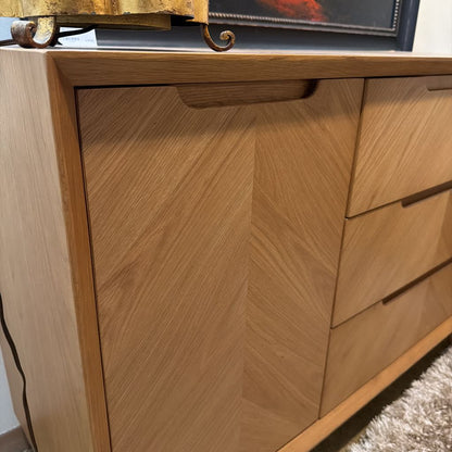 Wooden cabinet with a chevron pattern on a carpeted floor