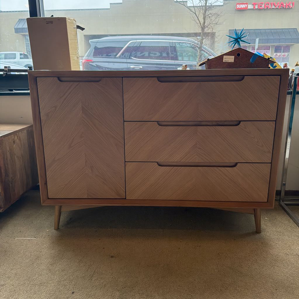Wooden dresser with two drawers in a room with a car and building visible through a window.