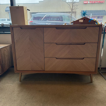 Wooden dresser with two drawers in a room with a car and building visible through a window.