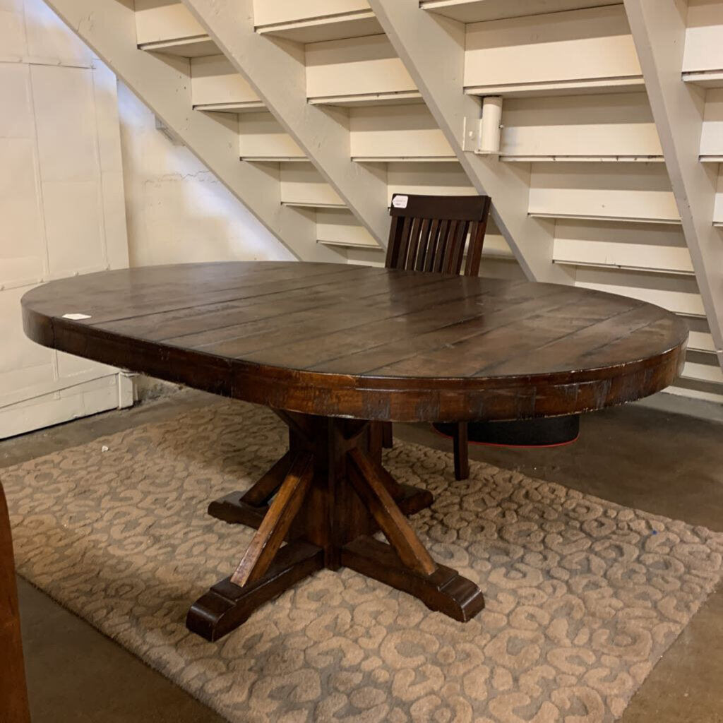 Wooden dining table with a chair underneath a staircase
