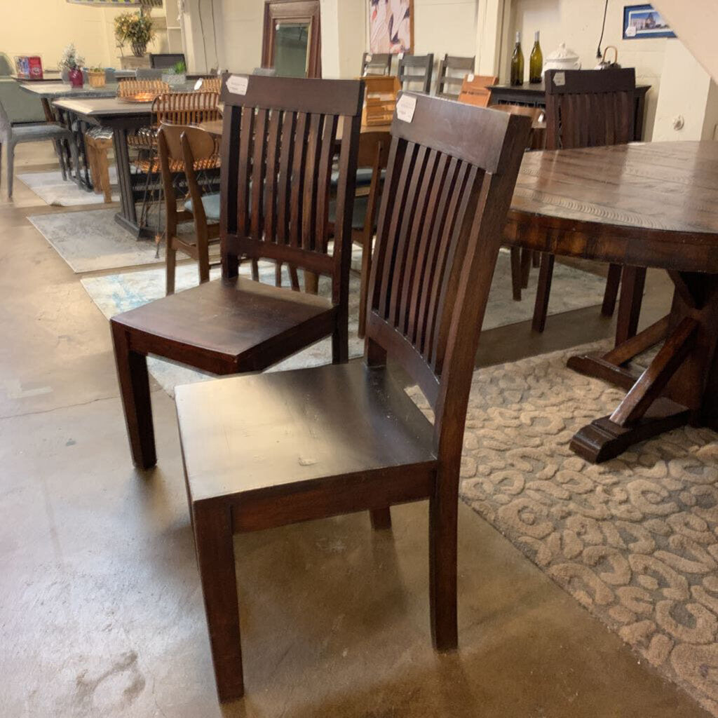 Wooden chairs and dining tables in a showroom setting
