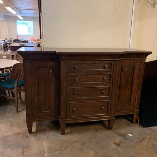 Wooden sideboard with drawers in a warehouse setting