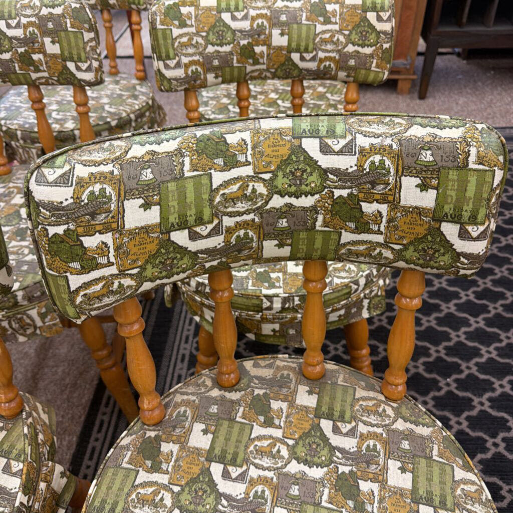 Set of chairs with patterned fabric and wooden legs on a carpeted floor.