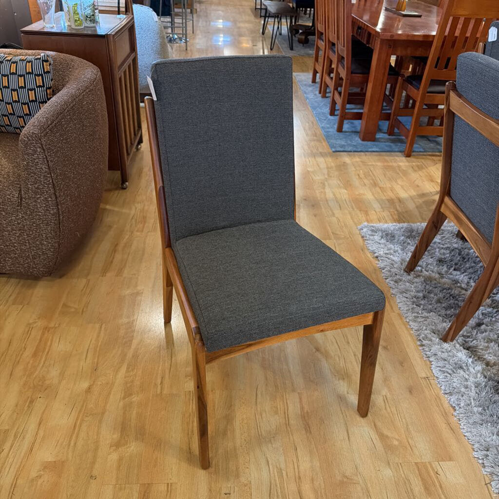 Dining room with wooden chairs and tables on a wooden floor.