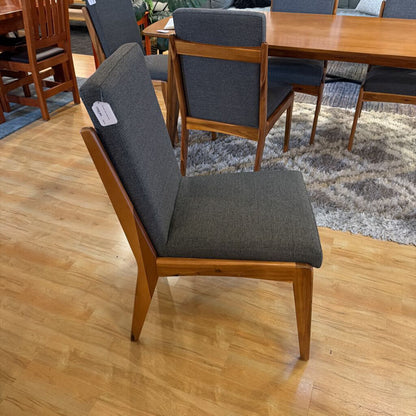 Dining chair with gray cushion on a wooden floor