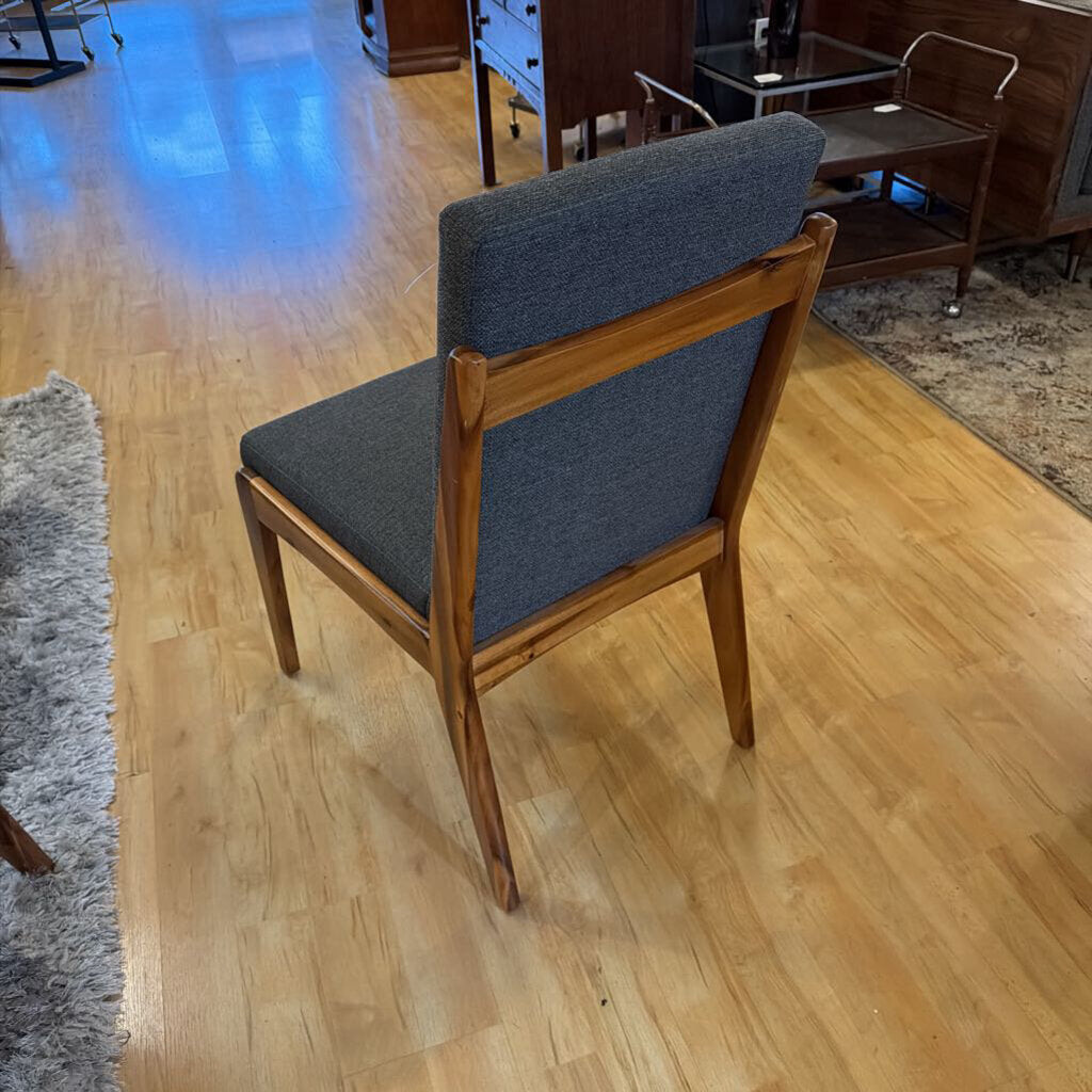 Wooden chair with gray cushion on a wooden floor