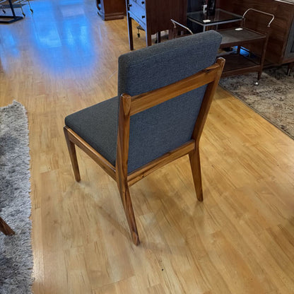 Wooden chair with gray cushion on a wooden floor