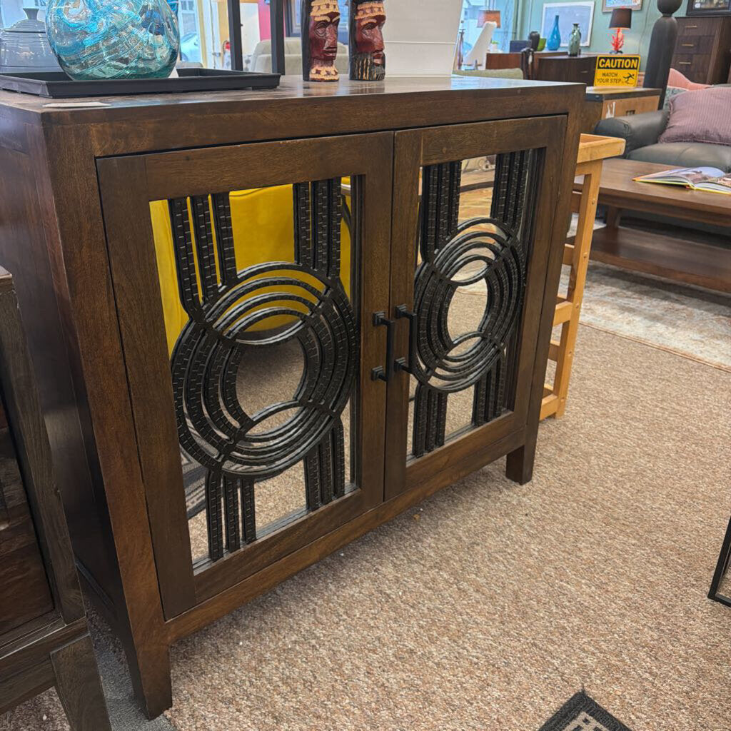 Wooden cabinet with decorative metal grilles in a store setting