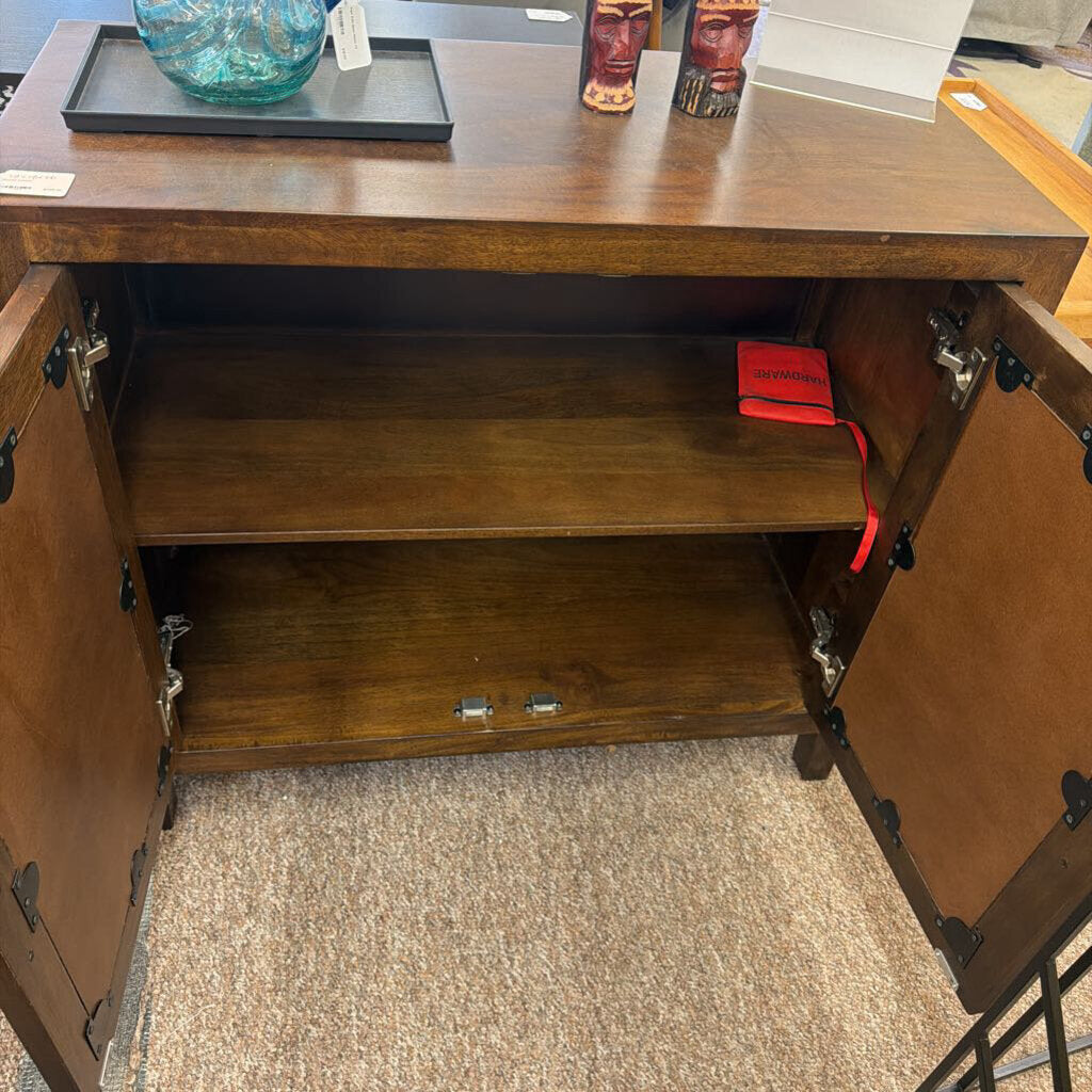 Wooden cabinet with open doors on a carpeted floor