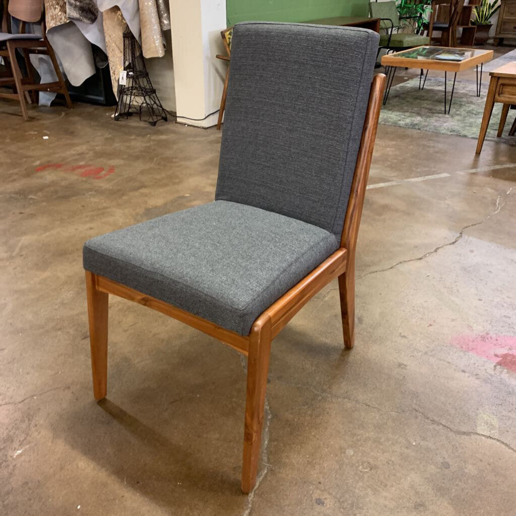 Chair with gray cushioned seat and backrest on a concrete floor.