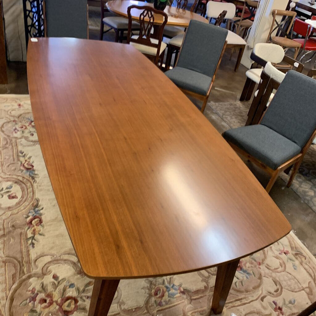 Wooden dining table with chairs in a room setting