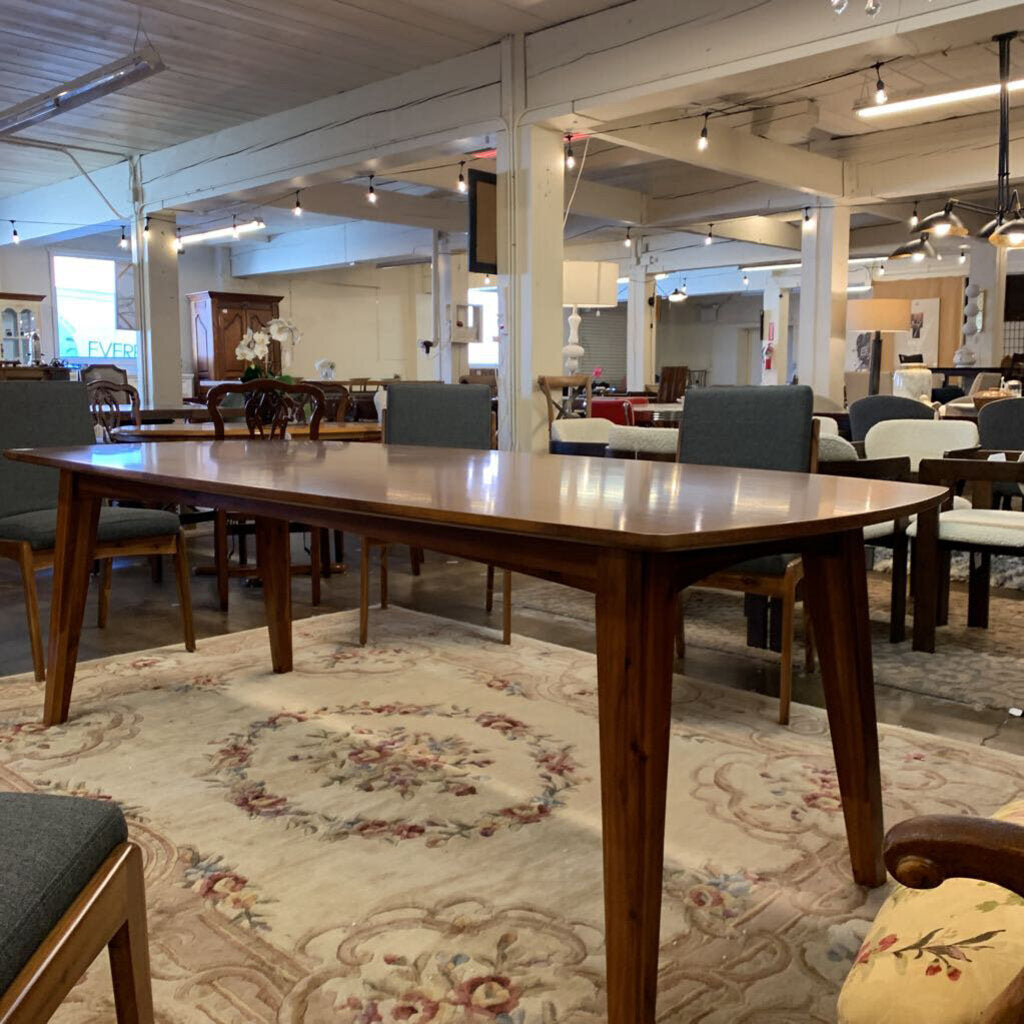 Dining room with wooden table and chairs on a patterned rug