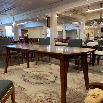 Dining room with wooden table and chairs on a patterned rug