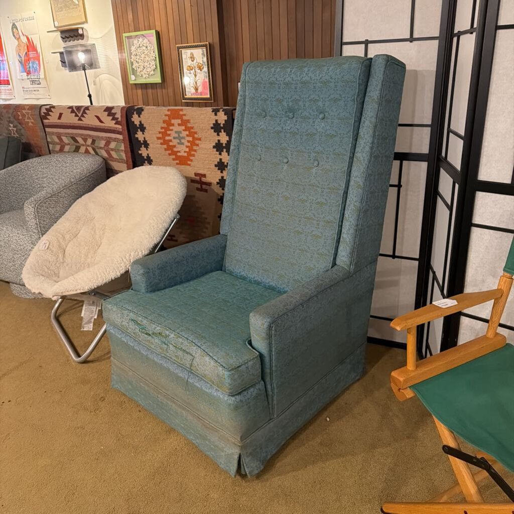 Blue armchair in a room with other furniture and decor