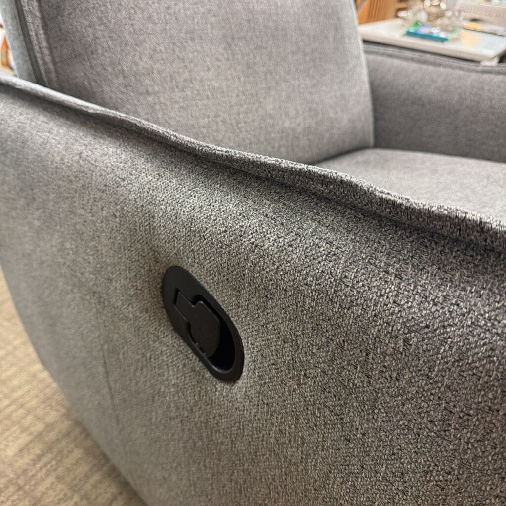 Gray textured armchair with a visible brand logo on a blurred background