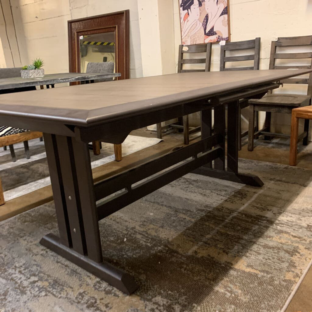 Dining table with benches in a room with chairs and a rug.