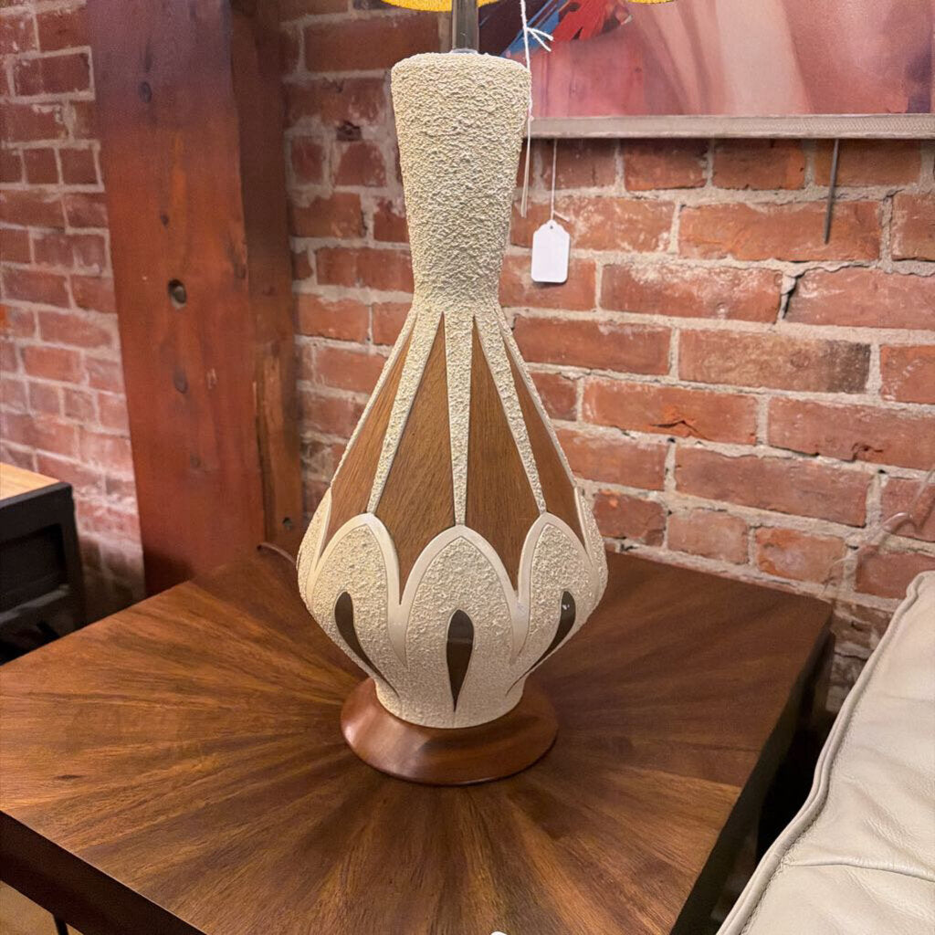 Decorative lamp on a wooden table with a brick wall background