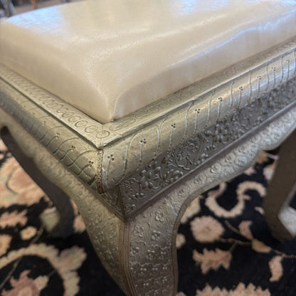 Decorative stool with intricate patterns on a patterned rug
