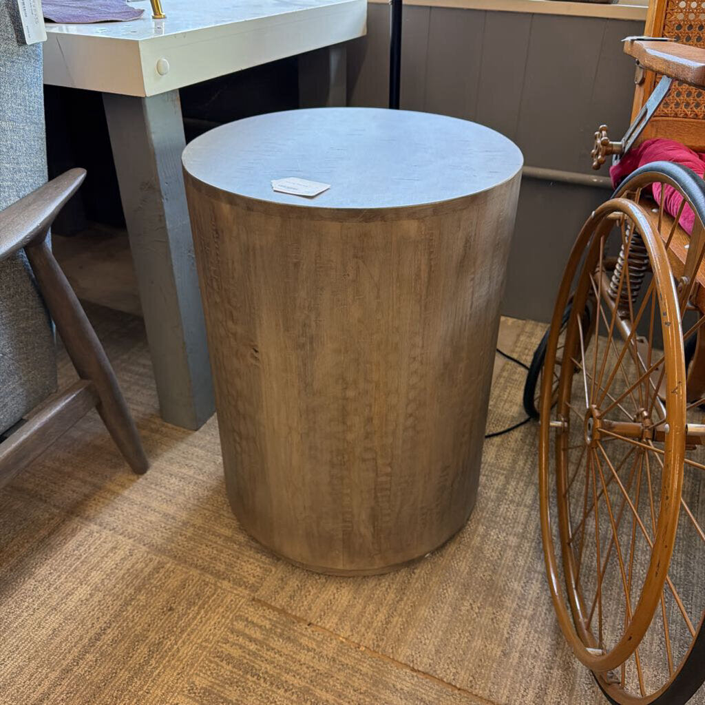 Drum-style end table with smooth cylindrical silhouette
