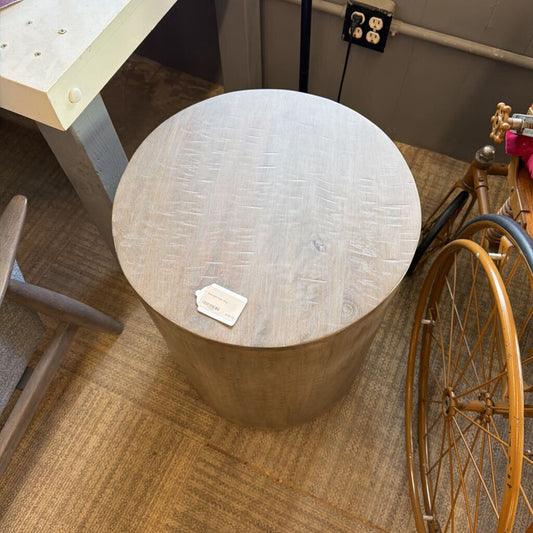 Drum-style end table with smooth cylindrical silhouette