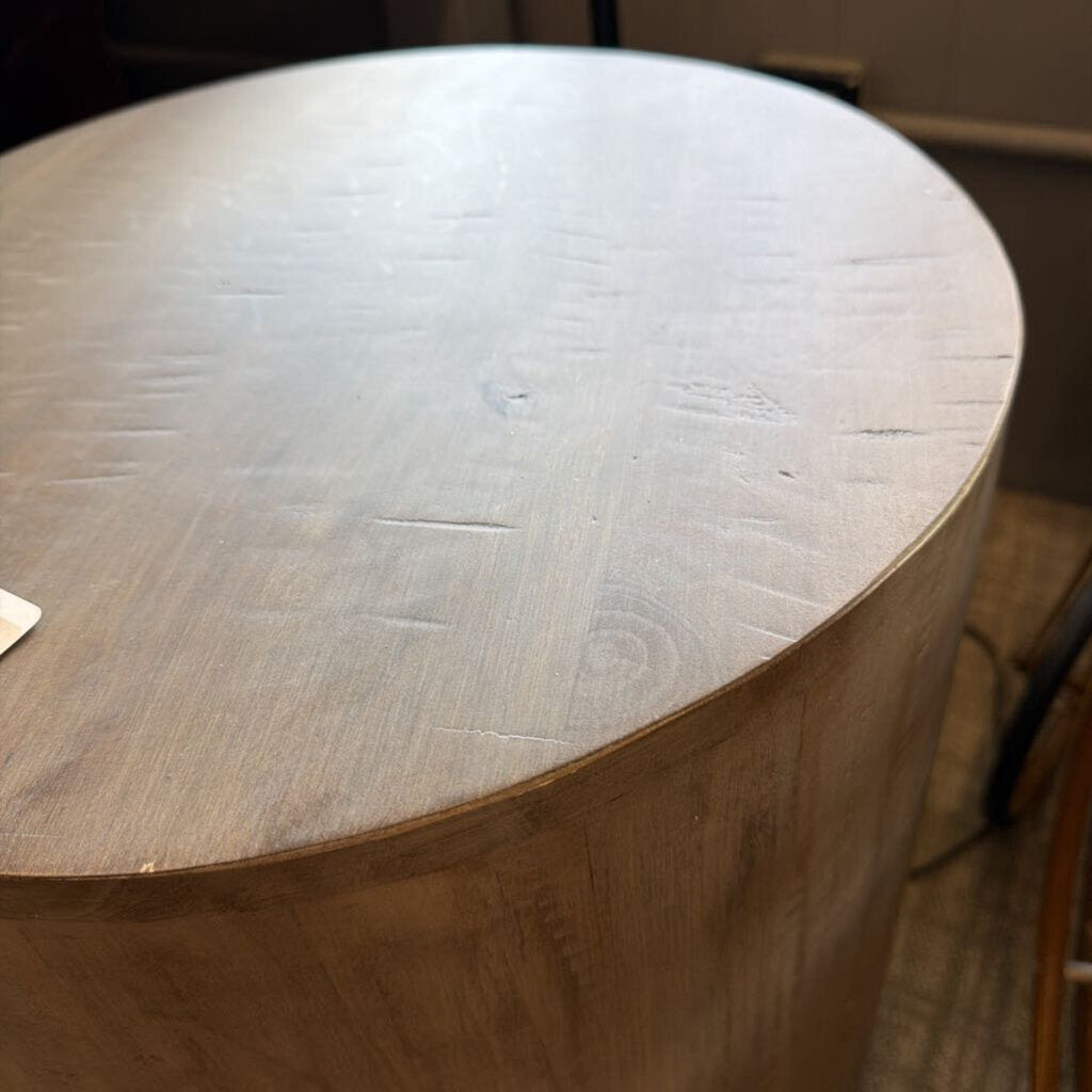 Drum-style end table with smooth cylindrical silhouette