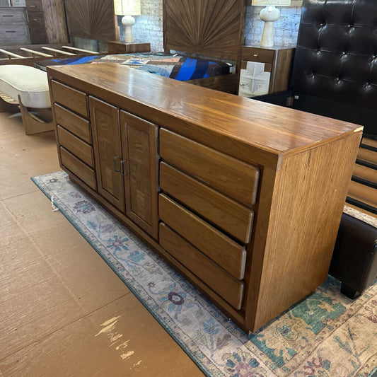 Wooden dresser with multiple drawers in a room setting