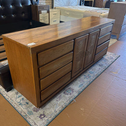 Wooden dresser with multiple drawers in a room setting