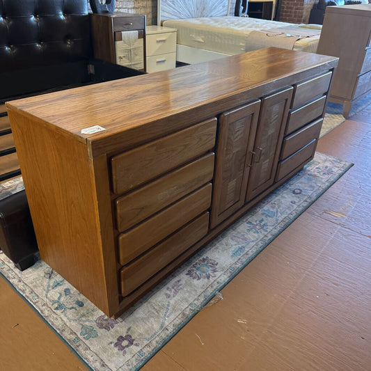 Wooden dresser with multiple drawers in a room setting