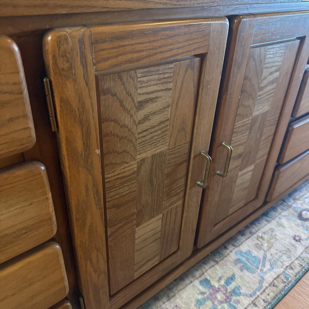 Wooden cabinet with paneled doors on a patterned rug