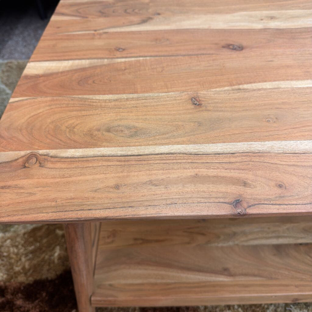 Wooden table with a natural finish, showing grain and color variations.