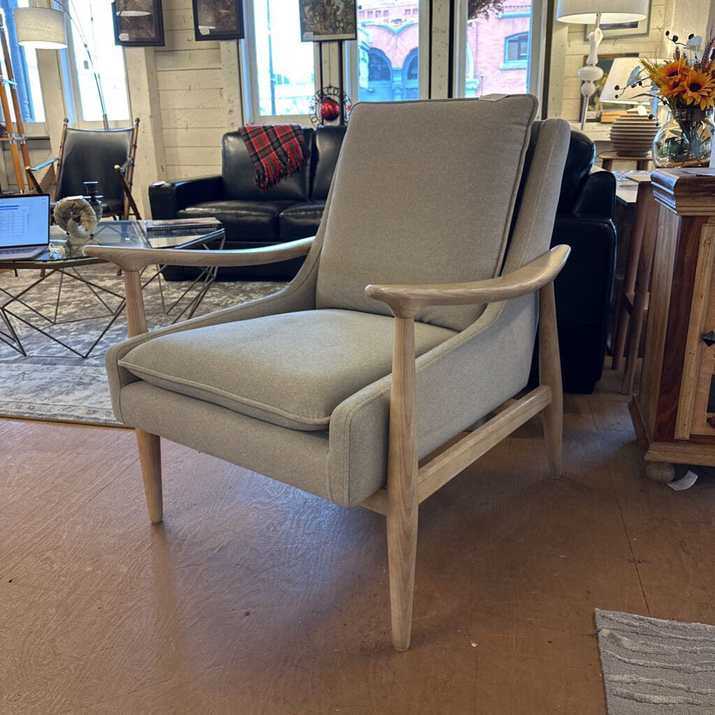 Beige armchair in a room with furniture and decor
