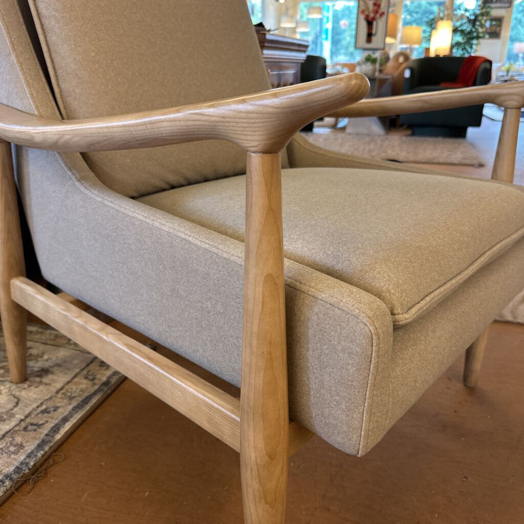 Beige armchair with wooden frame in a living room setting