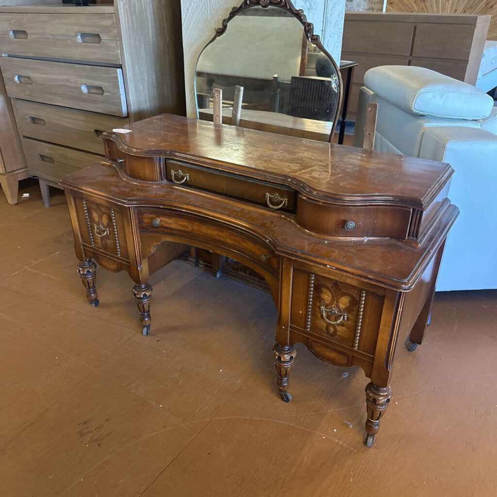 Wooden vanity with mirror on a brown floor