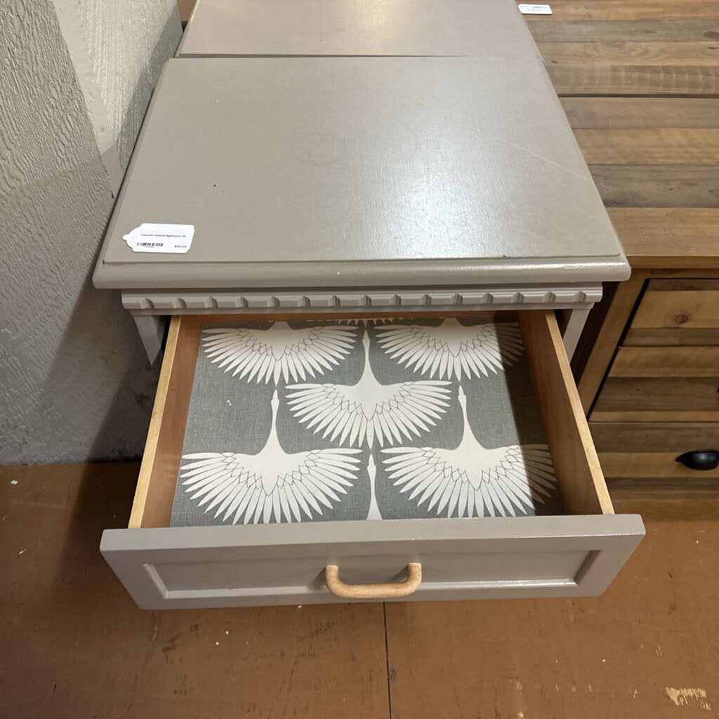 Gray drawer with a decorative interior on a wooden floor